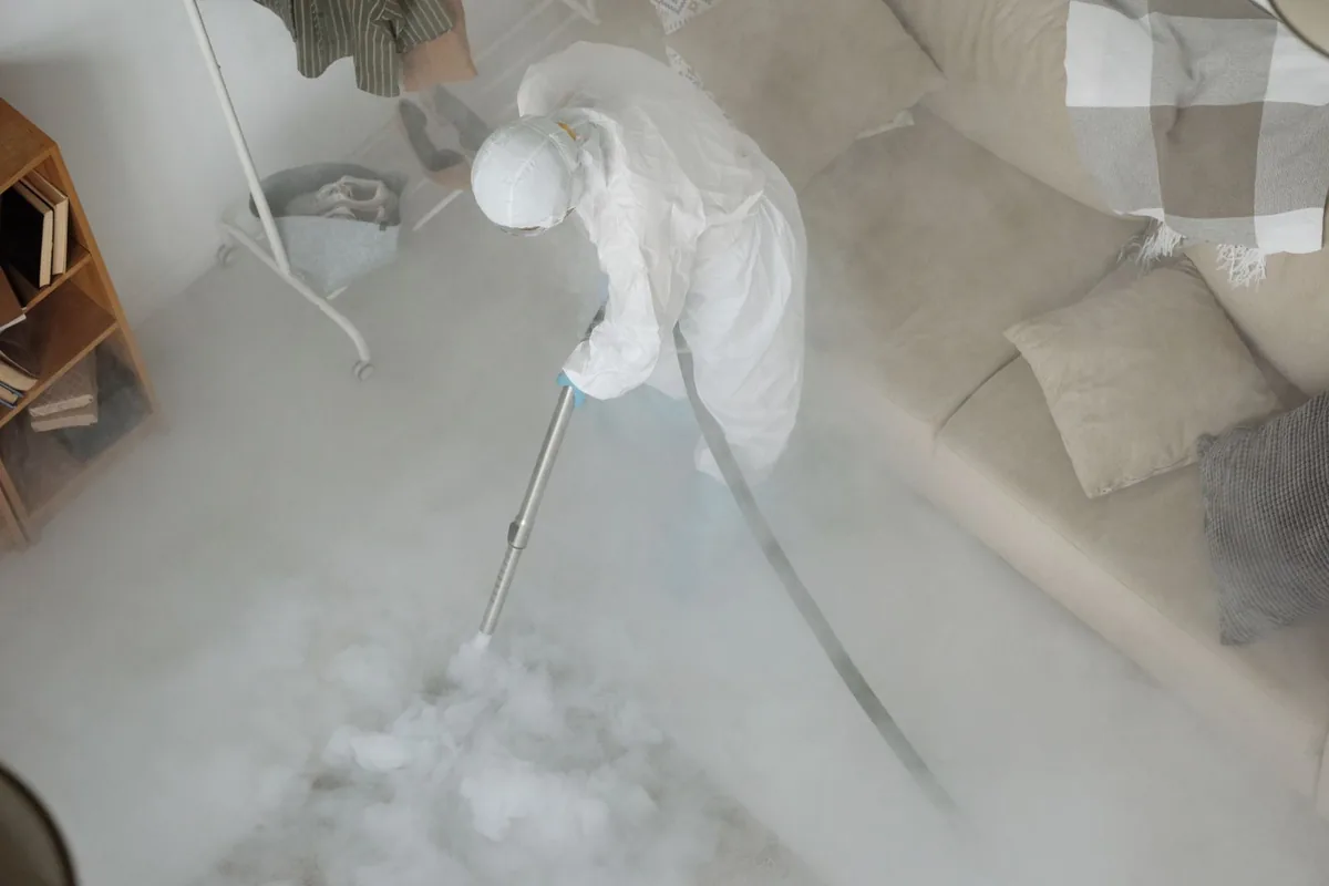 Biohazard cleanup technician in protective equipment, Milton, WA